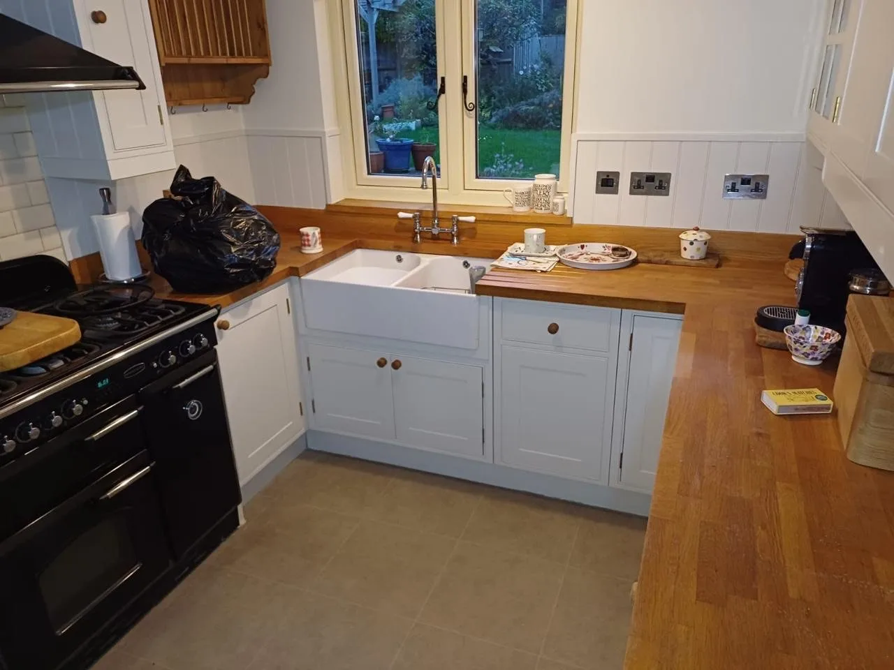 Hand-painted shaker kitchen in off-white with solid oak worktops and Belfast sink, kitchen respray by Bourne Decorators