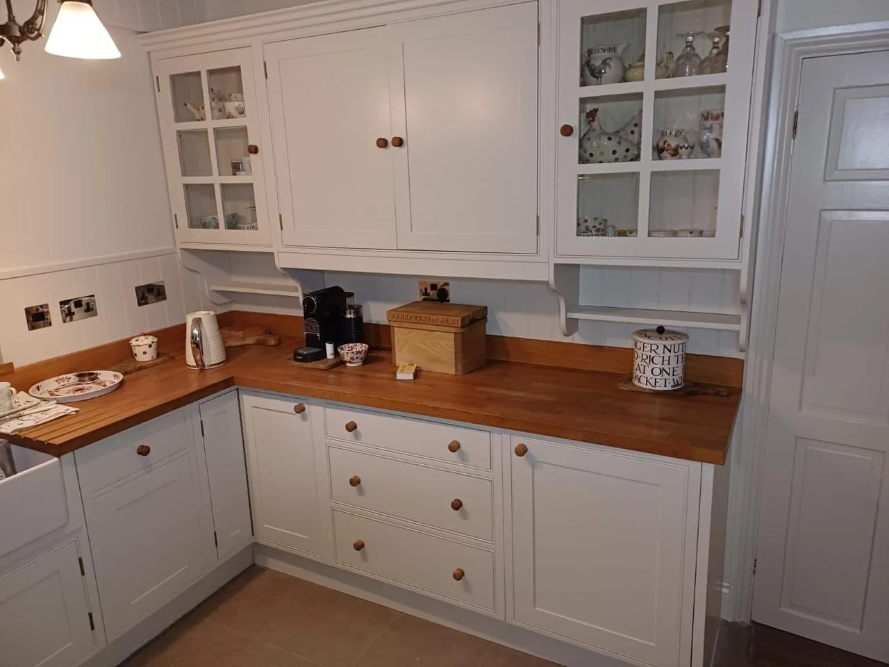 Repainted kitchen cabinets and glazed dressers finished in soft white, kitchen respray project by Bourne Decorators