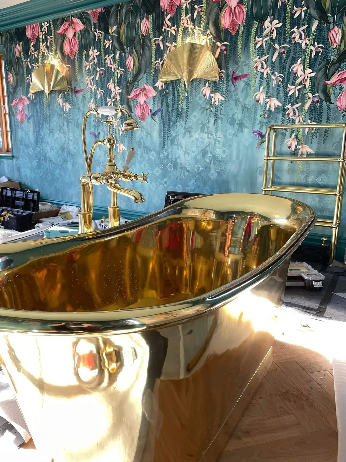 Detail of hand-hung floral mural wallpaper and brass wall lights, Bourne Decorators wallpapering project in Binstead, Hampshire
